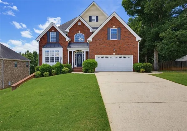 a front view of a house with a yard