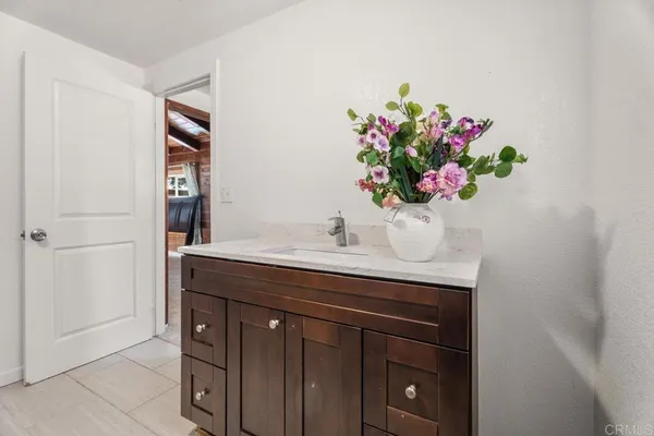 a bathroom with a sink a vanity and a mirror