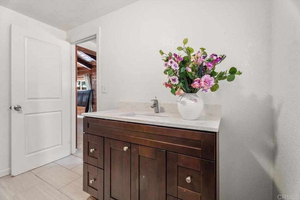 2758 Ribbonwood Road Boulevard, CA 91905 - Photo 14 of 38 a bathroom with a sink a vanity and a mirror