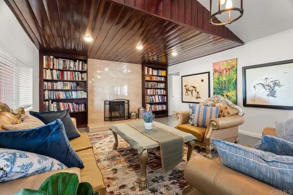 a living room with furniture fireplace and a large window