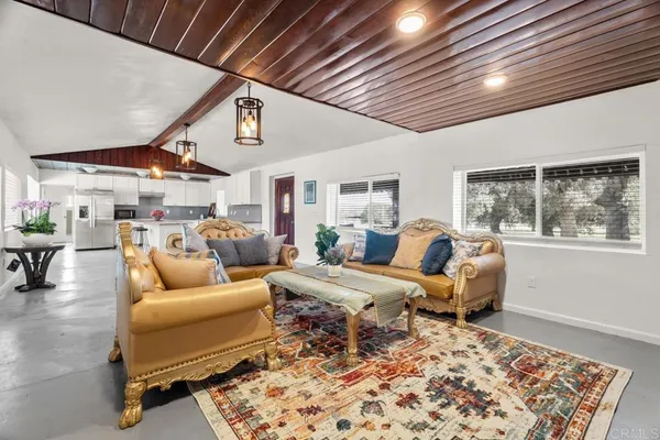 a living room with furniture ceiling fan and a rug