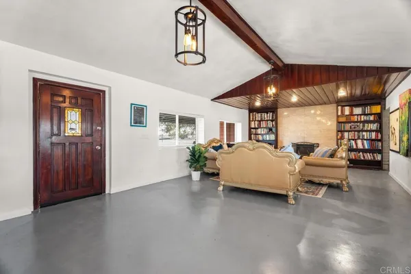 a living room with furniture and a ceiling fan