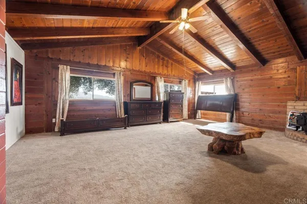 a view of a room with furniture and windows