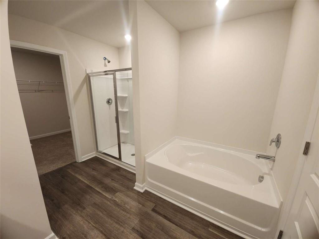 146 Aster Avenue Locust Grove, GA 30248 - Photo 14 of 28 a bathroom with a bathtub and a shower