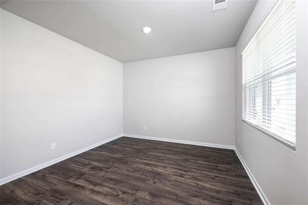 146 Aster Avenue Locust Grove, GA 30248 - Photo 16 of 28 wooden floor in an empty room with a window