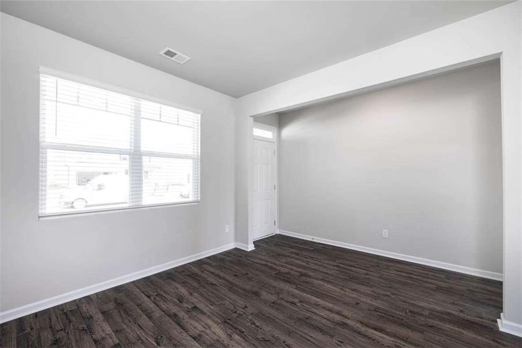 146 Aster Avenue Locust Grove, GA 30248 - Photo 17 of 28 an empty room with wooden floor and windows