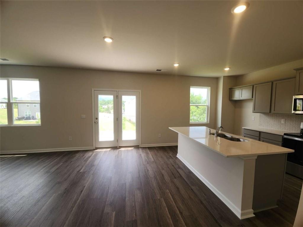 146 Aster Avenue Locust Grove, GA 30248 - Photo 5 of 28 a living room with stainless steel appliances granite countertop furniture wooden floor and a window