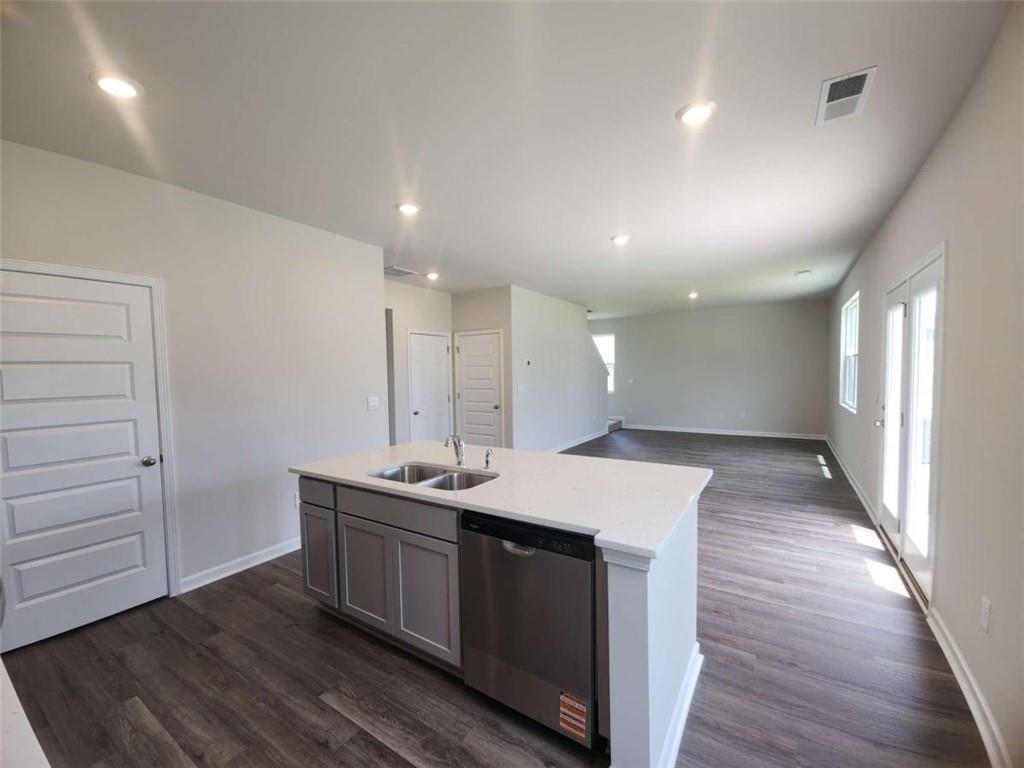 146 Aster Avenue Locust Grove, GA 30248 - Photo 7 of 28 a kitchen with a sink and wooden floor