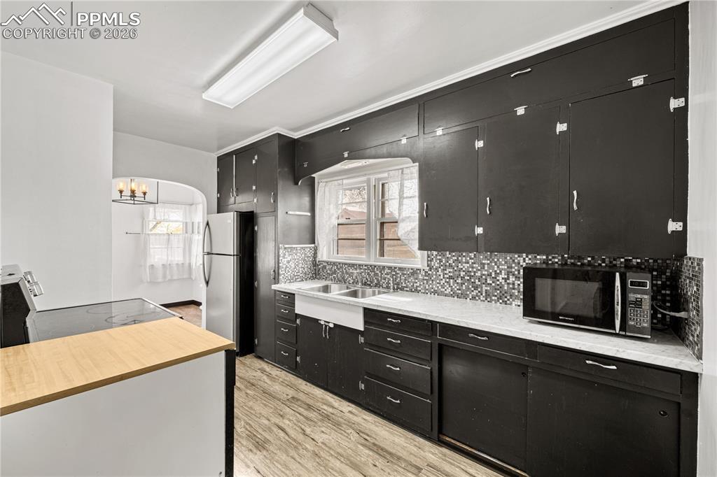 805 West Routt Avenue Pueblo, CO 81004 - Photo 15 of 27 a kitchen with a refrigerator and microwave