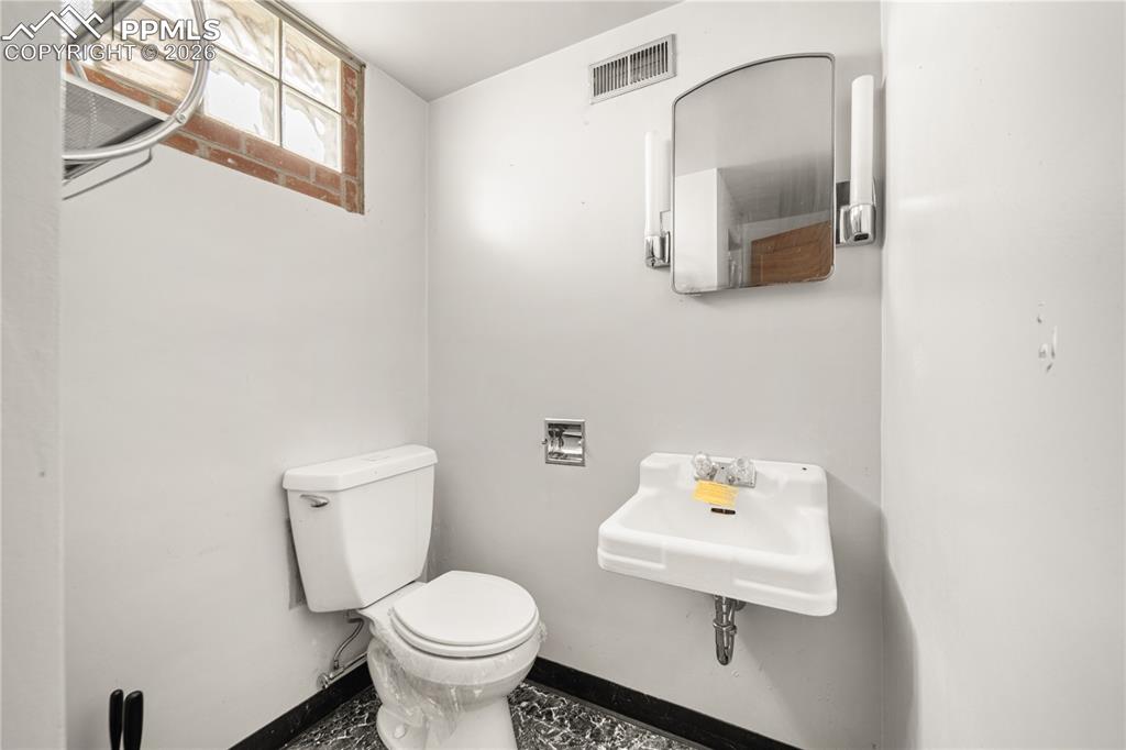 805 West Routt Avenue Pueblo, CO 81004 - Photo 20 of 27 a white toilet sitting next to a bathroom sink