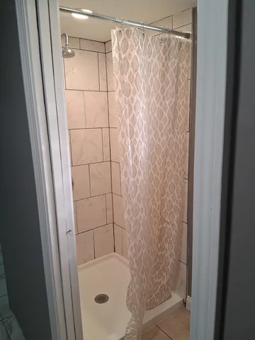 a bathroom with a shower and a sink