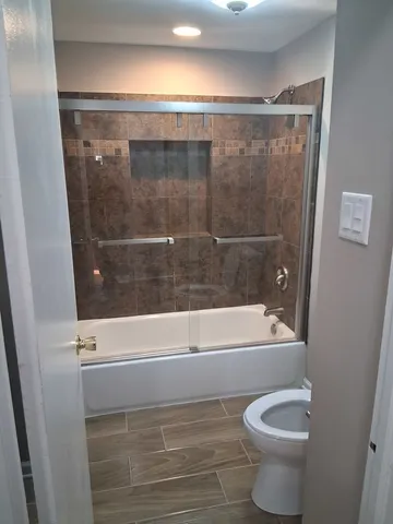 a bathroom with a shower and a toilet