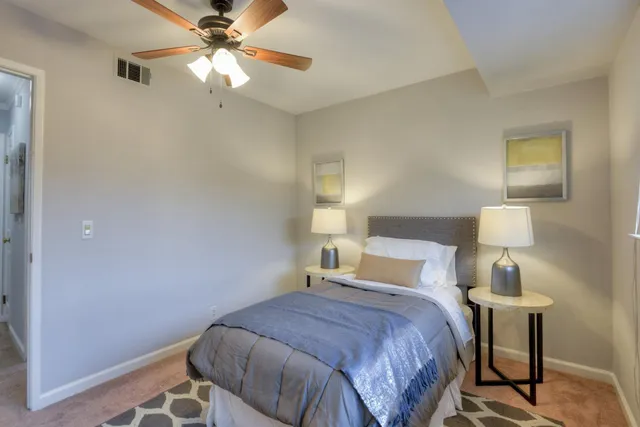 a bedroom with a bed and a lamp