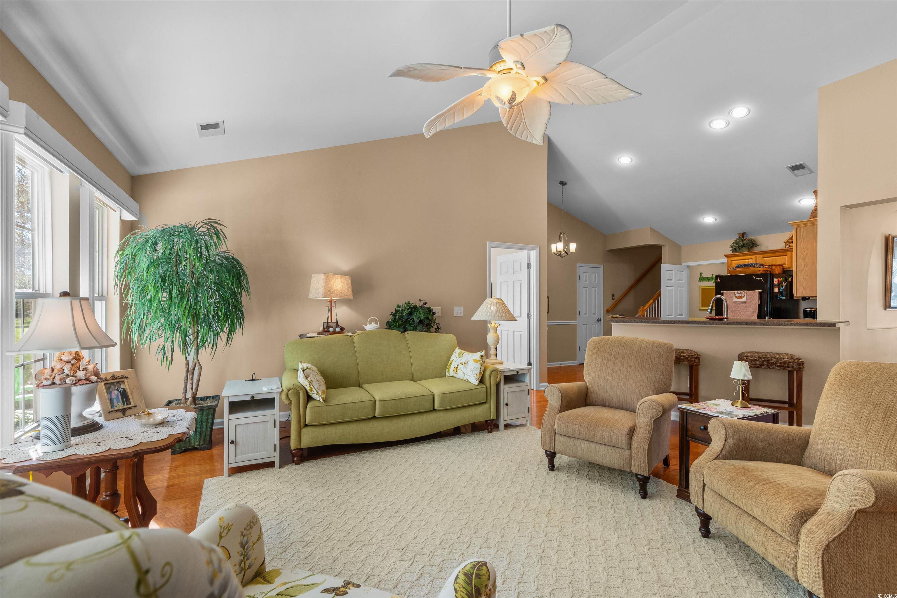 3505 Arrowhead Boulevard Myrtle Beach, SC 29579 - Photo 7 of 40 Living area with wood finished floors, a ceiling fan, high vaulted ceiling, and a chandelier