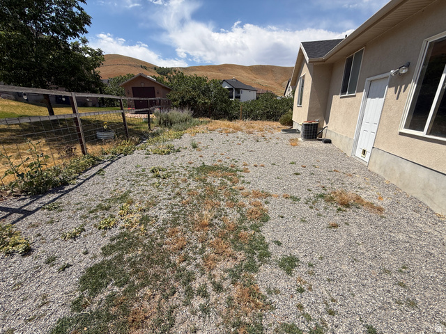 702 Elk Meadow Loop Tooele, UT 84074 - Photo 7 of 9 Gravel landscape area with a wire fence boundary
