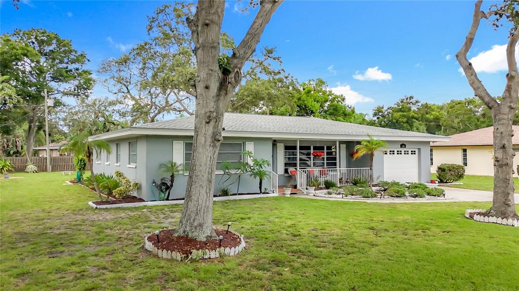 a front view of a house with a yard and green space
