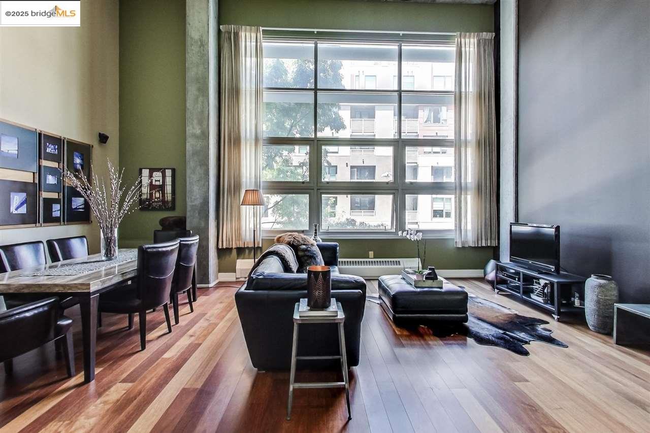 a living room with furniture a bookshelf and a flat screen tv