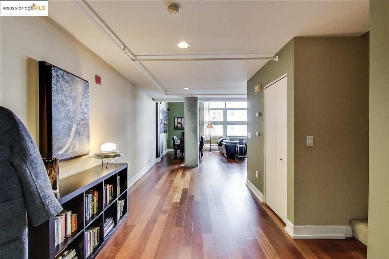 311 Oak Street, Unit 337 Oakland, CA 94607 - Photo 15 of 38 a view of a hallway with wooden floor and a living room