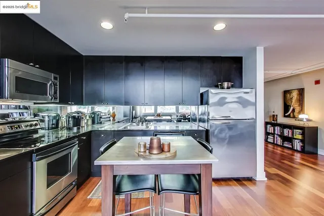 a kitchen with a table chairs microwave and cabinets