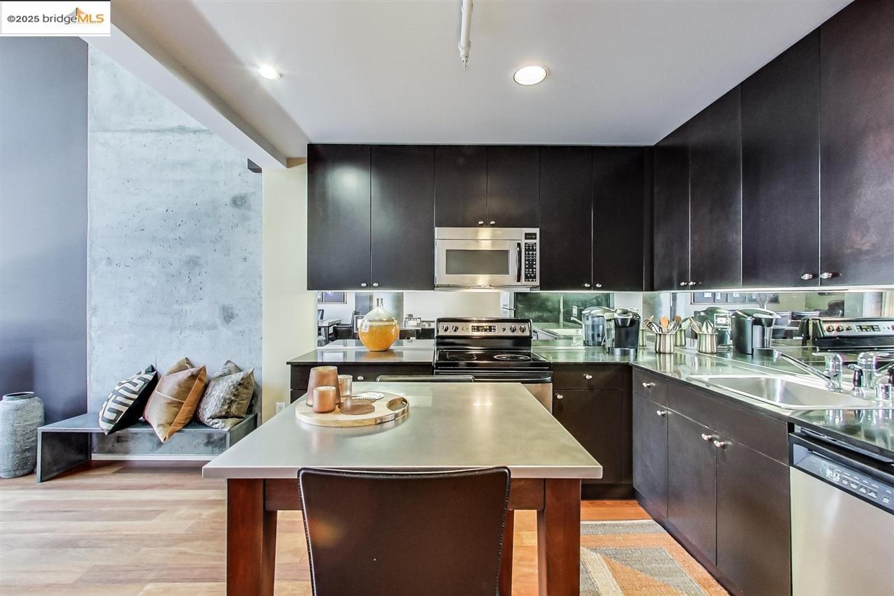311 Oak Street, Unit 337 Oakland, CA 94607 - Photo 18 of 38 a kitchen with a sink a stove cabinets and wooden floor