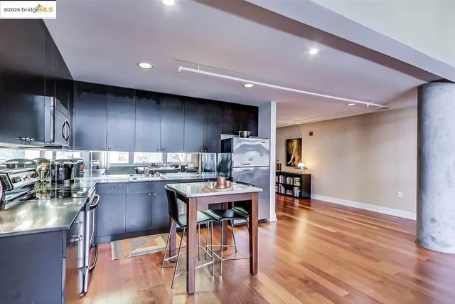 a kitchen with a table chairs refrigerator and wooden cabinets