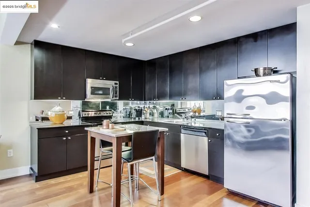 a kitchen with kitchen island granite countertop wooden cabinets and white appliances