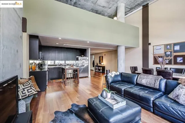 a living room with furniture and a kitchen view
