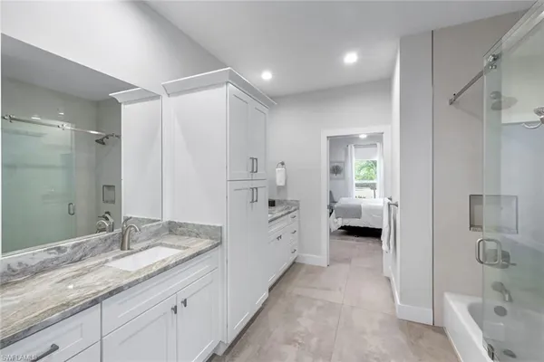 a spacious bathroom with a granite countertop sink mirror and a
