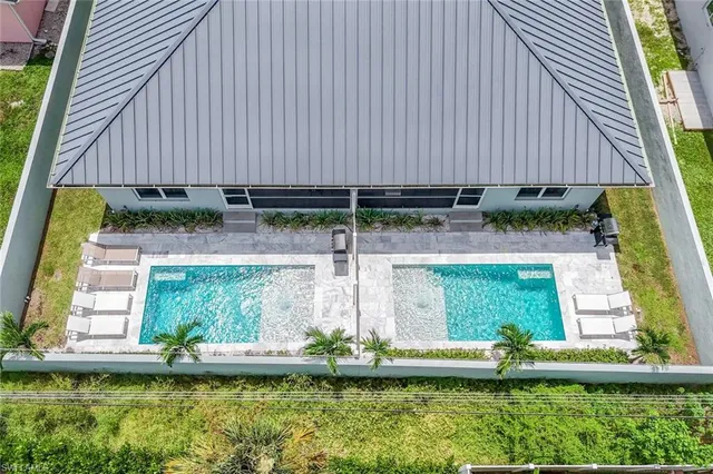 a view of swimming pool with a yard and plants