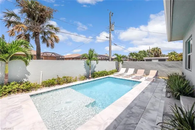 a view of a terrace with lawn chairs