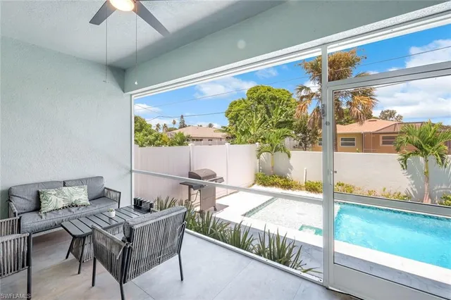 a view of a porch with furniture and a yard