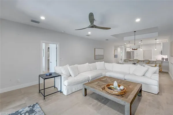 a living room with furniture and a chandelier