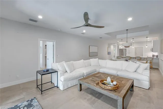 a living room with furniture and a chandelier