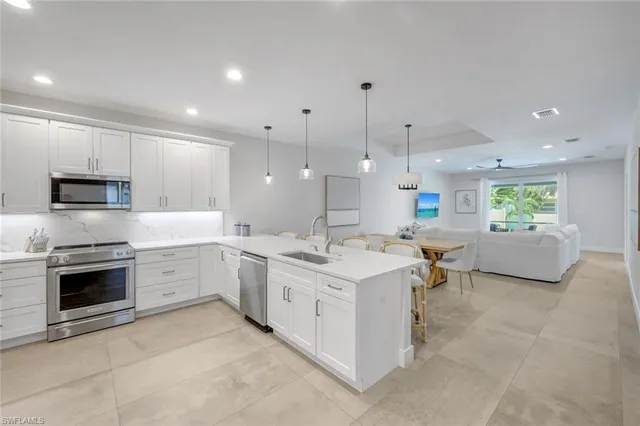 a kitchen with a sink stove and microwave