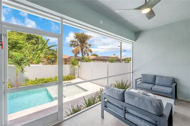 a living room with furniture and a floor to ceiling window