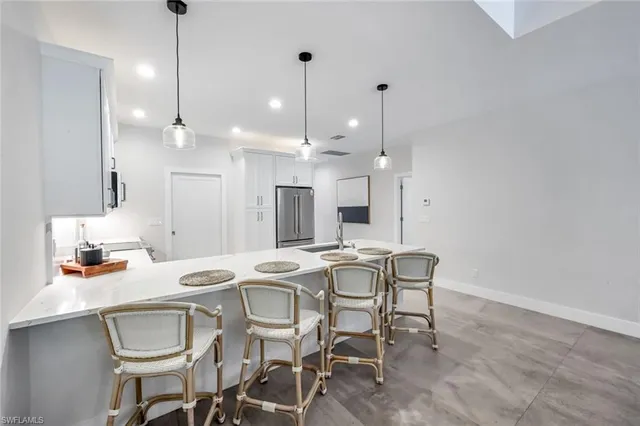 a dining room with granite countertop furniture and a floor to ceiling window