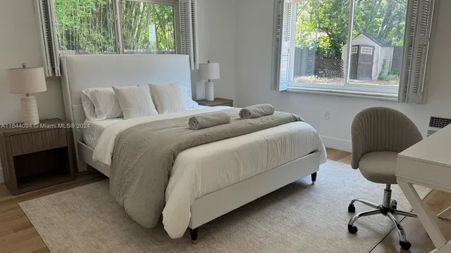 a view of a living room and kitchen with wooden floor