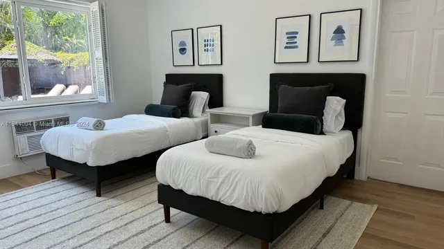 a dining room with furniture a chandelier and wooden floor
