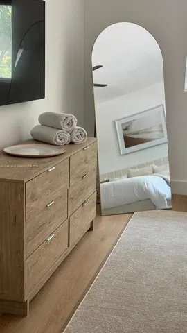 a dining room with furniture a window and wooden floor