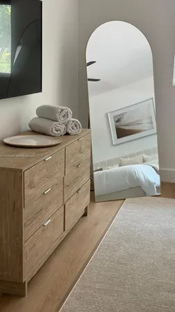 a dining room with furniture a window and wooden floor