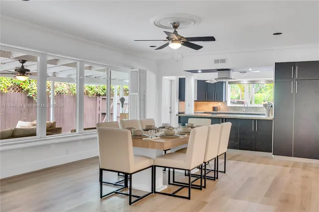 a bedroom with a bed dresser and a chandelier