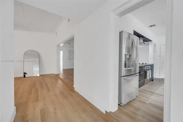 a spacious bedroom with a bed and a chandelier