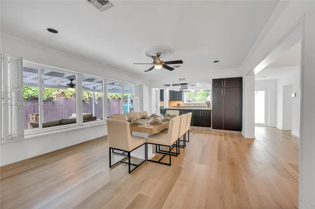 a view of a patio with a table chairs and a backyard