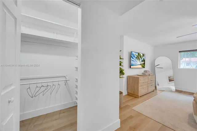 a view of a patio with a table and chairs under an umbrella