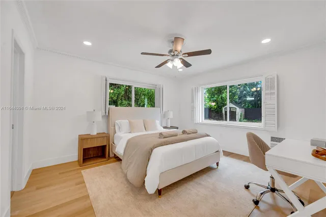 a view of a patio with table and chairs potted plants with floor to ceiling window