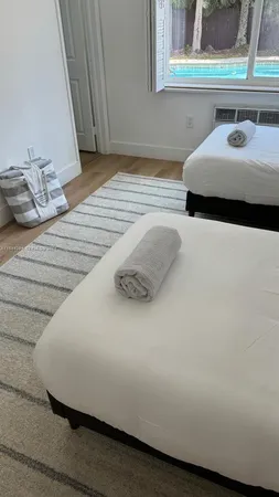 a living room with a couch and a potted plant