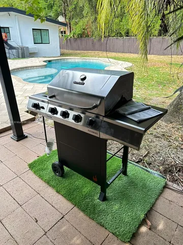 a living room with a couch and a potted plant