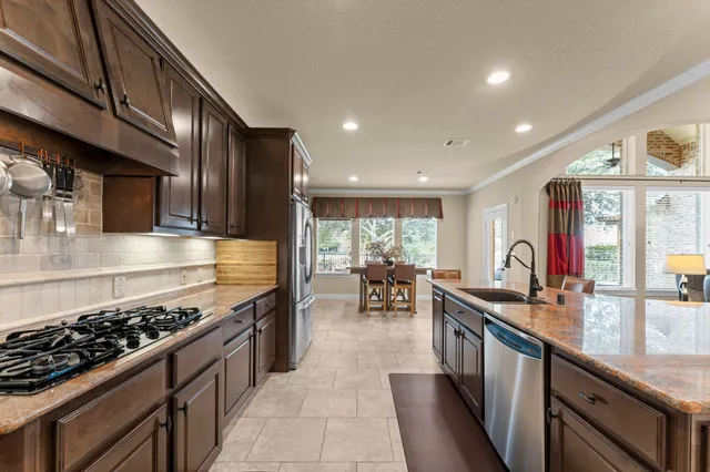 a kitchen with lots of counter top space stove sink and cabinets