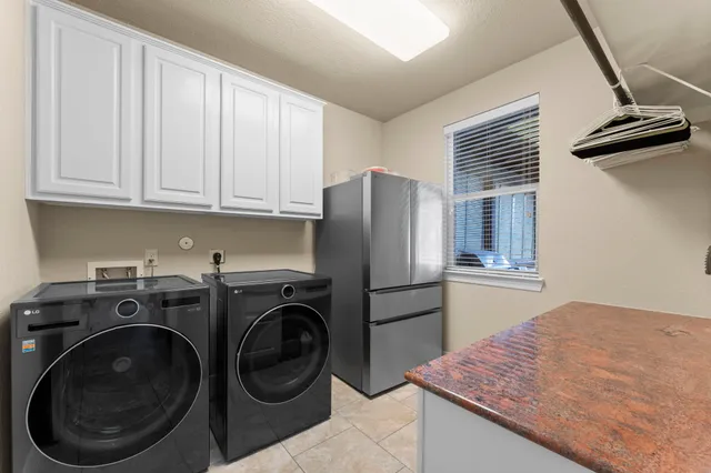 a kitchen with stainless steel appliances granite countertop a refrigerator sink and cabinets