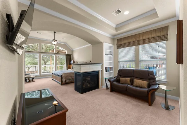 a living room with furniture a fireplace and a flat screen tv